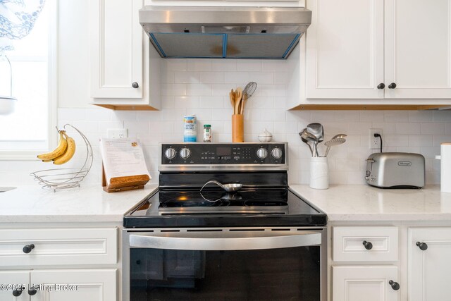 816 Snead Ct, Simpsonville, KY 40067 - kitchen with stainless steel electric stove, range hood, white cabinetry, and tasteful backsplash