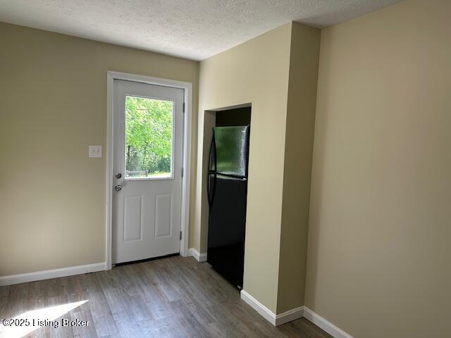 4515 Wolf Creek Rd, Battletown, KY 40104 - doorway featuring wood finished floors, a textured ceiling, and baseboards