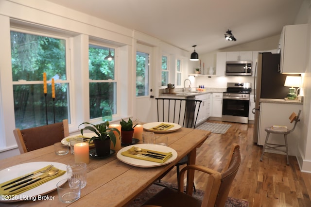 456 E Brandeis Ave, Louisville, KY 40217 - dining space with wood finished floors and vaulted ceiling