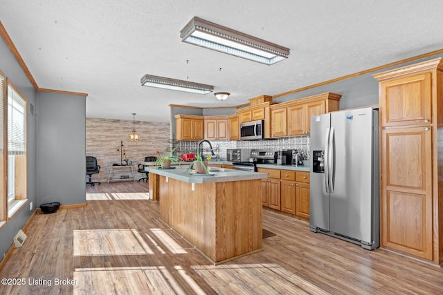 1210 Christian Church Rd, Brandenburg, KY 40108 - kitchen with appliances with stainless steel finishes, a textured ceiling, light wood-style flooring, an island with sink, and light countertops