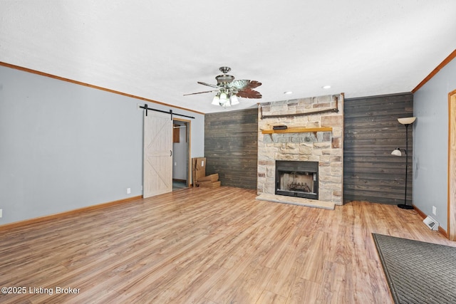 1210 Christian Church Rd, Brandenburg, KY 40108 - unfurnished living room with a stone fireplace, a ceiling fan, wood walls, baseboards, and ornamental molding