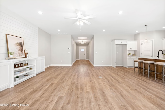 801 Artisan Pkwy, La Grange, KY 40031 - unfurnished living room with recessed lighting, ceiling fan, light wood-style flooring, baseboards, and a sink