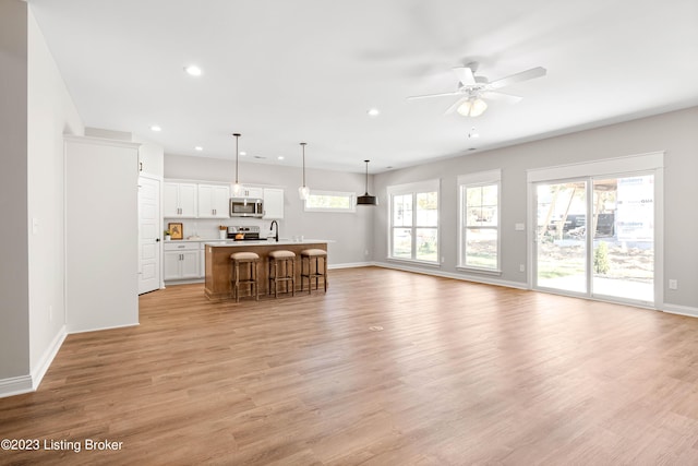 801 Artisan Pkwy, La Grange, KY 40031 - unfurnished living room with recessed lighting, baseboards, light wood finished floors, and a ceiling fan