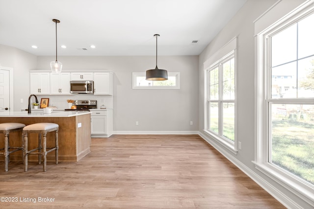 801 Artisan Pkwy, La Grange, KY 40031 - kitchen featuring appliances with stainless steel finishes, plenty of natural light, white cabinetry, and recessed lighting
