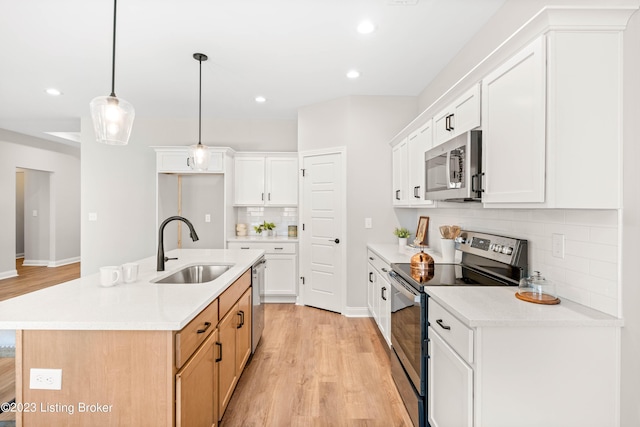 801 Artisan Pkwy, La Grange, KY 40031 - kitchen featuring stainless steel appliances, a sink, backsplash, light wood-style flooring, and light countertops