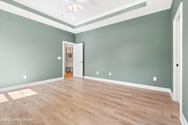 801 Artisan Pkwy, La Grange, KY 40031 - unfurnished bedroom featuring a raised ceiling, crown molding, light wood-style floors, and baseboards
