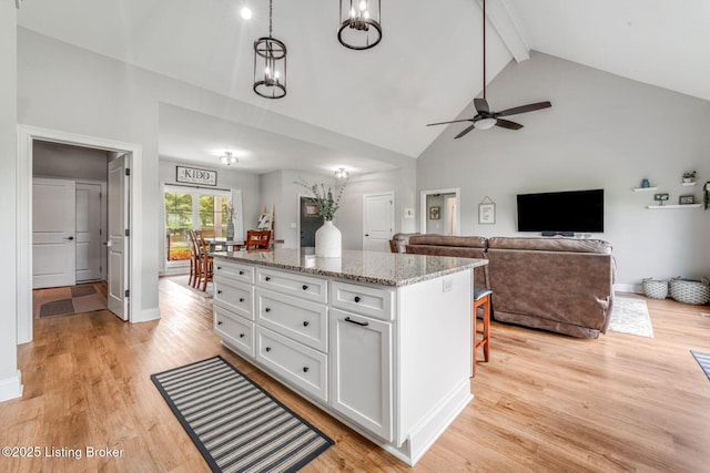 458 Christman Ln, Shepherdsville, KY 40165 - kitchen featuring white cabinets, high vaulted ceiling, beam ceiling, a ceiling fan, and a kitchen island