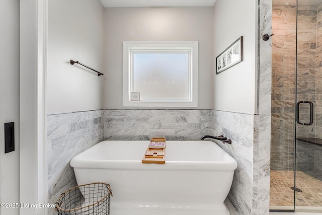 458 Christman Ln, Shepherdsville, KY 40165 - bathroom with tile walls, a shower stall, a freestanding tub, and a wainscoted wall