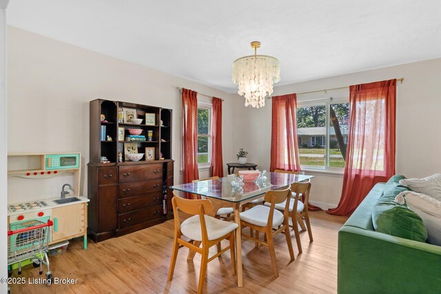 607 Edgemont Rd, Irvington, KY 40146 - dining area featuring a chandelier and light wood-style flooring