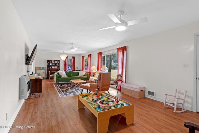 607 Edgemont Rd, Irvington, KY 40146 - living room featuring a ceiling fan, light wood-style floors, baseboards, and heating unit