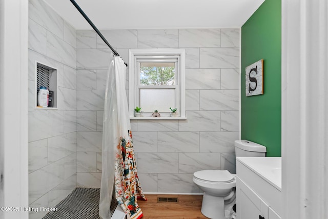 607 Edgemont Rd, Irvington, KY 40146 - full bath featuring vanity, a stall shower, toilet, and wood finished floors