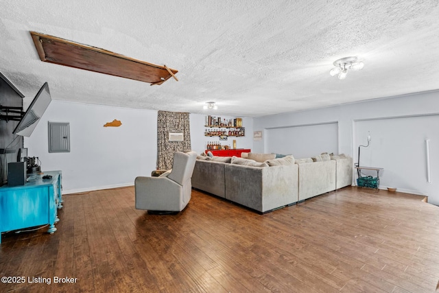 607 Edgemont Rd, Irvington, KY 40146 - living room with a textured ceiling, wood finished floors, electric panel, and baseboards