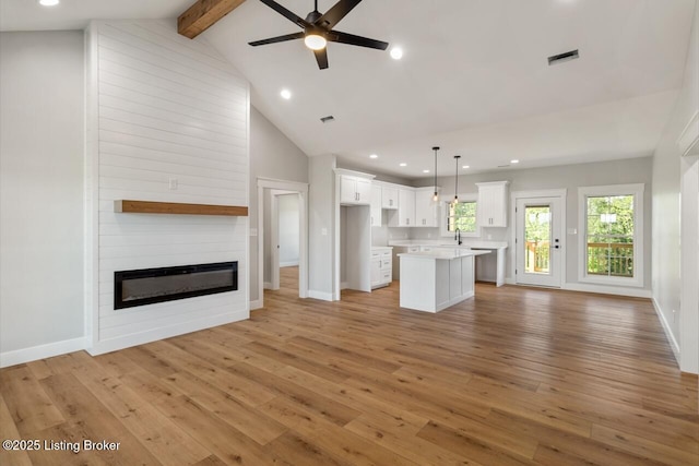 506 Capps Rd, Campbellsville, KY 42718 - unfurnished living room featuring recessed lighting, light wood-style flooring, a ceiling fan, a large fireplace, and baseboards