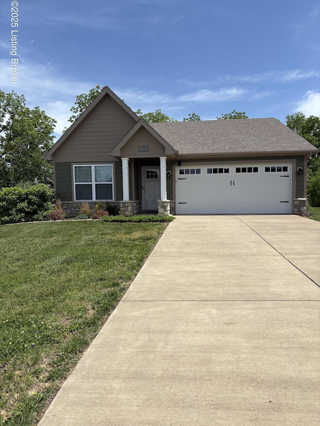 7997 Pikewood Field Way, Louisville, KY 40219 - craftsman-style home with stone siding, an attached garage, concrete driveway, and a front lawn