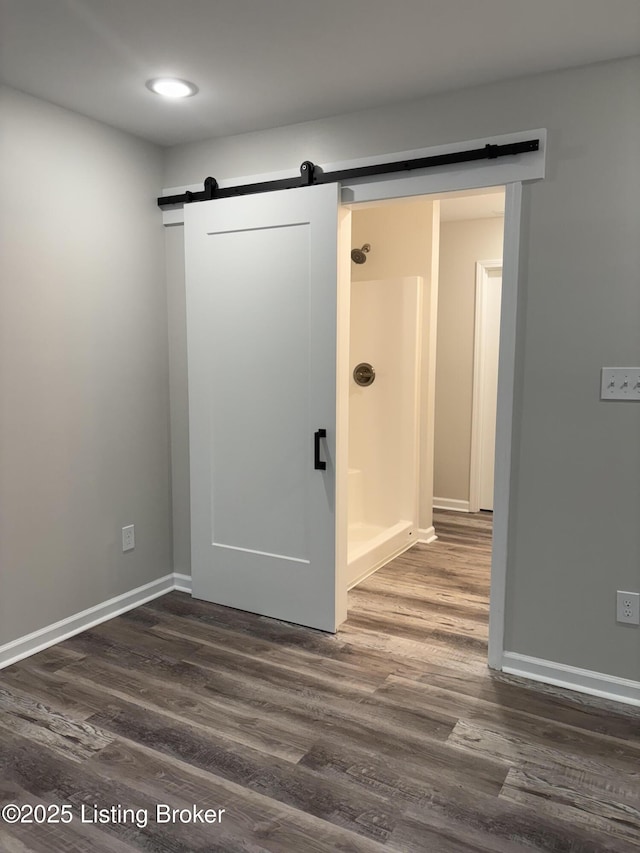 7997 Pikewood Field Way, Louisville, KY 40219 - unfurnished room featuring a barn door, dark wood finished floors, baseboards, and recessed lighting