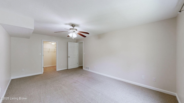 85 Summitt Dr, Brandenburg, KY 40108 - unfurnished bedroom featuring carpet floors, a walk in closet, baseboards, and a ceiling fan