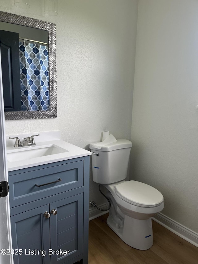 75 Labrador Way, Rineyville, KY 40162 - full bathroom with baseboards, wood finished floors, vanity, and toilet