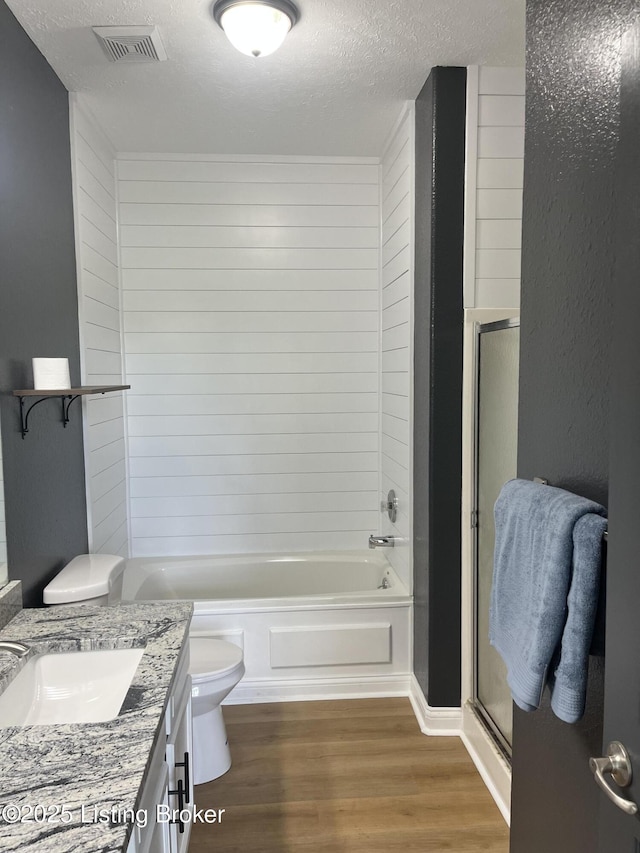 75 Labrador Way, Rineyville, KY 40162 - bathroom featuring toilet, wood finished floors, a textured ceiling, vanity, and shower / bath combination with glass door