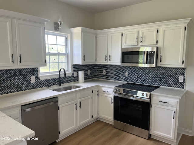 75 Labrador Way, Rineyville, KY 40162 - kitchen featuring stainless steel appliances, a sink, light wood-style flooring, and white cabinetry