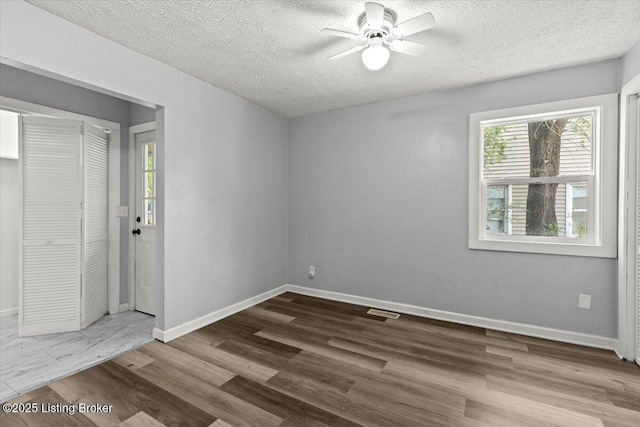 404 Diecks Dr, Elizabethtown, KY 42701 - unfurnished room featuring ceiling fan, wood finished floors, a textured ceiling, and baseboards