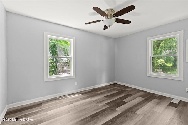 404 Diecks Dr, Elizabethtown, KY 42701 - unfurnished room featuring healthy amount of natural light, wood finished floors, and baseboards