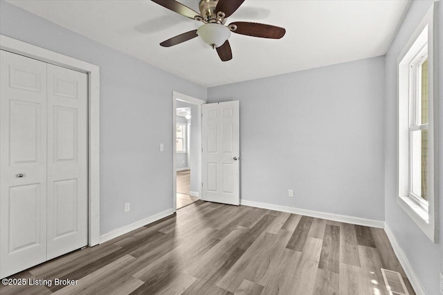 404 Diecks Dr, Elizabethtown, KY 42701 - unfurnished bedroom with multiple windows, wood finished floors, baseboards, and a closet