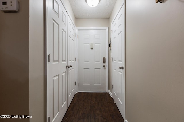 10207 Deer Vista Dr Unit 204, Louisville, KY 40291 - doorway with dark wood-type flooring, a textured ceiling, and baseboards