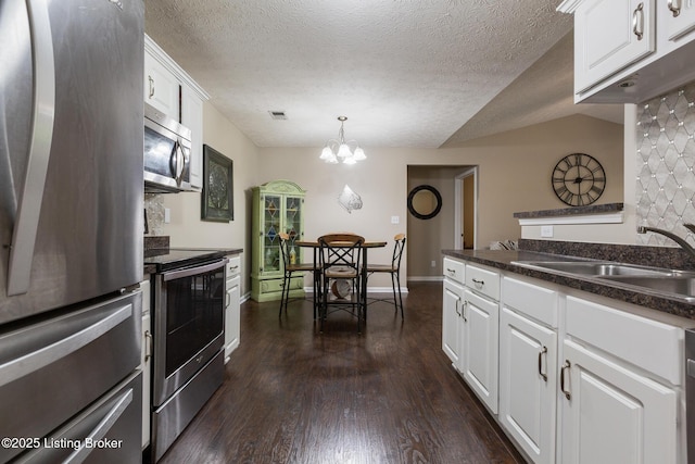 10207 Deer Vista Dr Unit 204, Louisville, KY 40291 - kitchen with stainless steel appliances, a sink, dark countertops, white cabinets, and dark wood finished floors