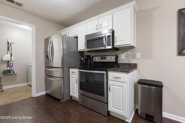 10207 Deer Vista Dr Unit 204, Louisville, KY 40291 - kitchen with stainless steel appliances, dark countertops, decorative backsplash, white cabinetry, and dark wood finished floors