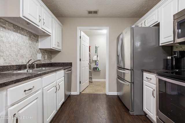 10207 Deer Vista Dr Unit 204, Louisville, KY 40291 - kitchen with stainless steel appliances, a sink, white cabinetry, backsplash, and a textured ceiling