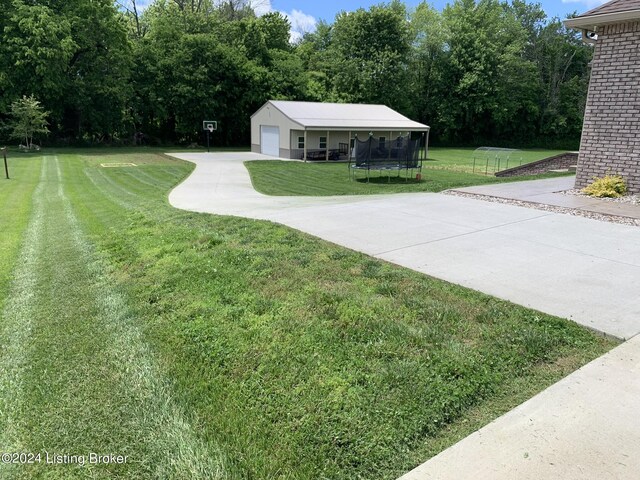 107 Clymene Rd, Cecilia, KY 42724 - view of green lawn featuring a trampoline and driveway