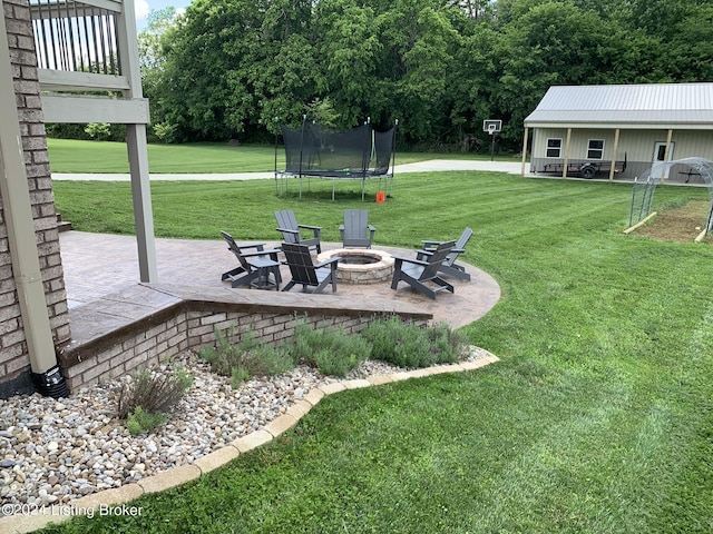 107 Clymene Rd, Cecilia, KY 42724 - view of green lawn with a patio area, a trampoline, and an outdoor fire pit
