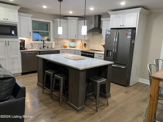 107 Clymene Rd, Cecilia, KY 42724 - kitchen with appliances with stainless steel finishes, wall chimney exhaust hood, a sink, light wood finished floors, and recessed lighting