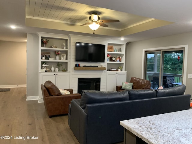 107 Clymene Rd, Cecilia, KY 42724 - living room with wood finished floors, baseboards, a ceiling fan, and a tray ceiling