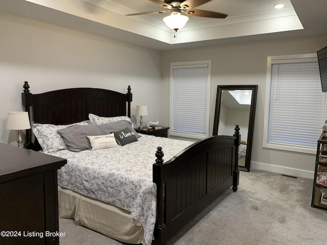 107 Clymene Rd, Cecilia, KY 42724 - bedroom featuring a tray ceiling, light carpet, baseboards, and a ceiling fan