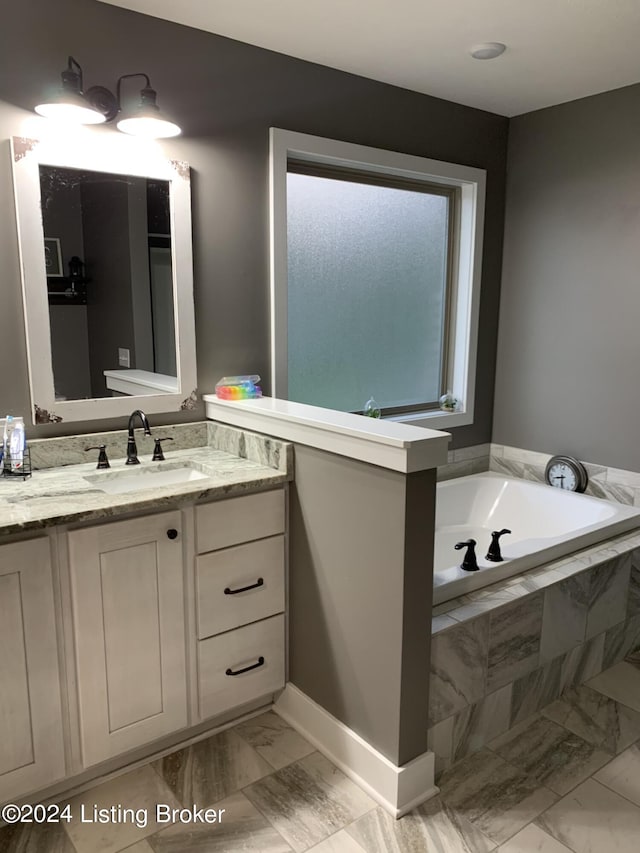107 Clymene Rd, Cecilia, KY 42724 - full bath with marble look tiles, vanity, a bath, and baseboards