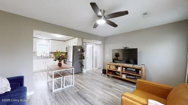 10003 Larlyn Dr, Fairdale, KY 40118 - living area featuring a ceiling fan and light wood-type flooring