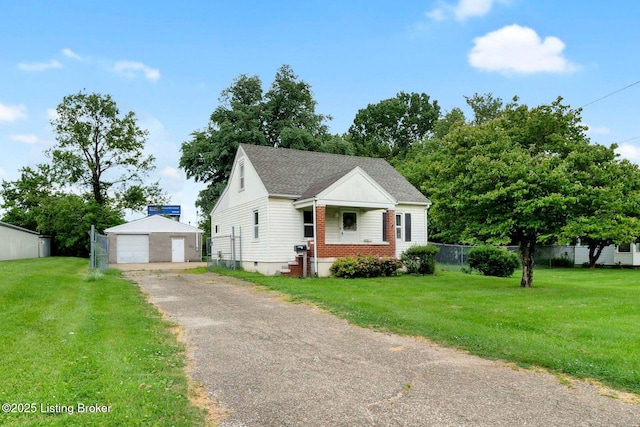 4309 Cavelle Ave, Louisville, KY 40213 - view of front of home with an outbuilding, a detached garage, driveway, and roof with shingles