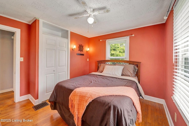 4309 Cavelle Ave, Louisville, KY 40213 - bedroom with light wood finished floors, baseboards, a textured ceiling, crown molding, and ceiling fan
