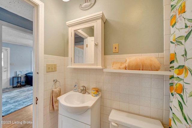 4309 Cavelle Ave, Louisville, KY 40213 - full bath with vanity, tile walls, wood finished floors, toilet, and curtained shower