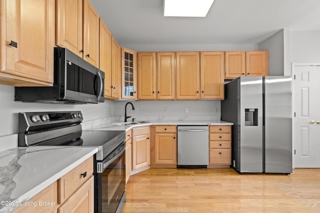 5106 Telford Ln, Louisville, KY 40241 - kitchen with stainless steel appliances, a sink, light wood-style floors, light brown cabinetry, and light countertops