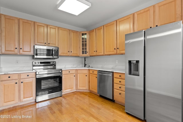 5106 Telford Ln, Louisville, KY 40241 - kitchen with appliances with stainless steel finishes, light brown cabinets, a sink, and light wood finished floors