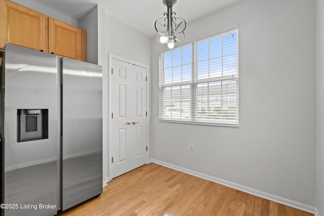 5106 Telford Ln, Louisville, KY 40241 - kitchen featuring stainless steel fridge, light wood finished floors, baseboards, hanging light fixtures, and a chandelier