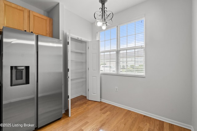 5106 Telford Ln, Louisville, KY 40241 - kitchen featuring stainless steel fridge, light wood finished floors, baseboards, hanging light fixtures, and a chandelier
