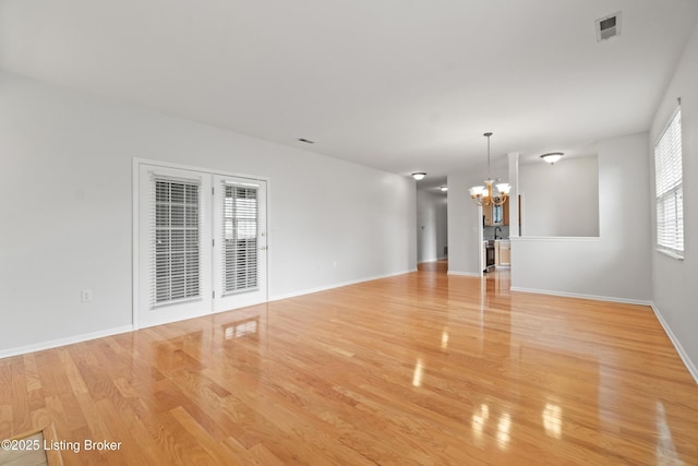 5106 Telford Ln, Louisville, KY 40241 - unfurnished living room with a chandelier, light wood finished floors, and baseboards