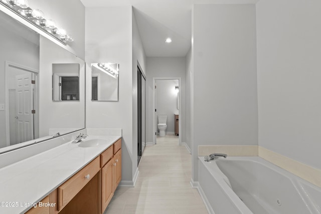 5106 Telford Ln, Louisville, KY 40241 - full bathroom featuring a garden tub, vanity, toilet, and baseboards