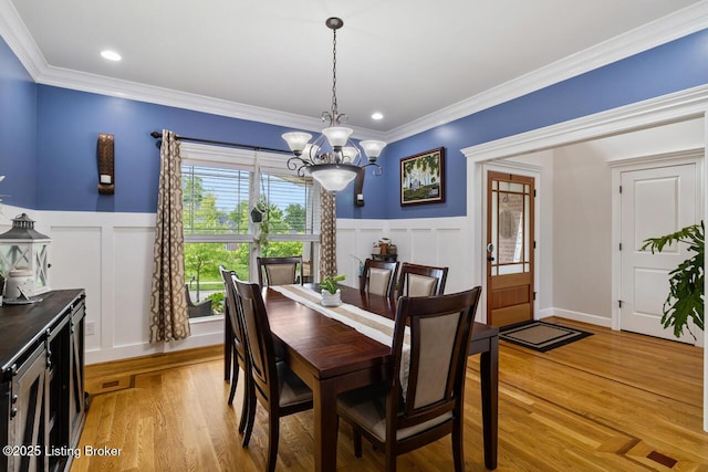 13318 Stepping Stone Way, Louisville, KY 40299 - dining room with a chandelier, a decorative wall, ornamental molding, light wood-style flooring, and wainscoting