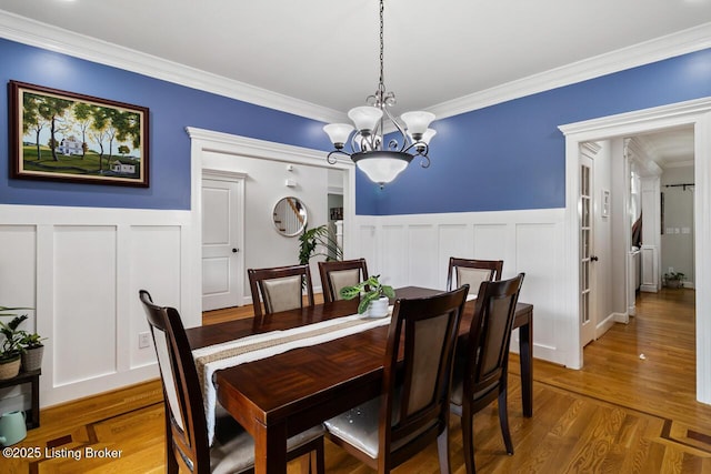 13318 Stepping Stone Way, Louisville, KY 40299 - dining area with a chandelier, crown molding, wainscoting, a decorative wall, and wood finished floors