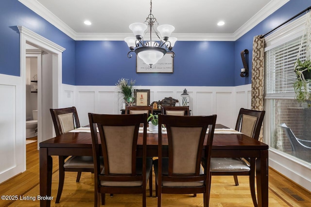 13318 Stepping Stone Way, Louisville, KY 40299 - dining area with a chandelier, wainscoting, a decorative wall, light wood-type flooring, and ornamental molding