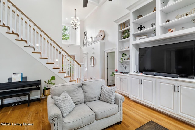 13318 Stepping Stone Way, Louisville, KY 40299 - living room featuring a high ceiling, a chandelier, light wood-style flooring, and stairway